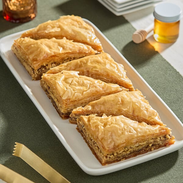 A plate of Kontos fillo dough pastries on a table.