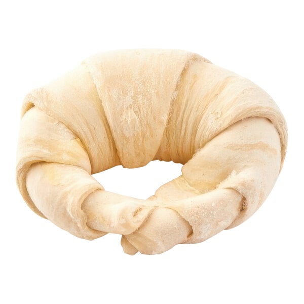 Croissant dough with a buttery texture pinched into a croissant shape.