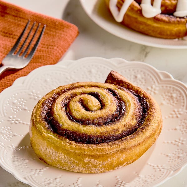 Pillsbury Plus frozen cinnamon roll on a plate with a fork.
