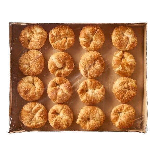 A tray of sliced fully baked croissant buns.