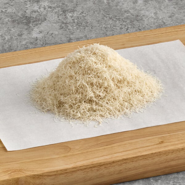 A pile of shredded noodles on a wooden board.