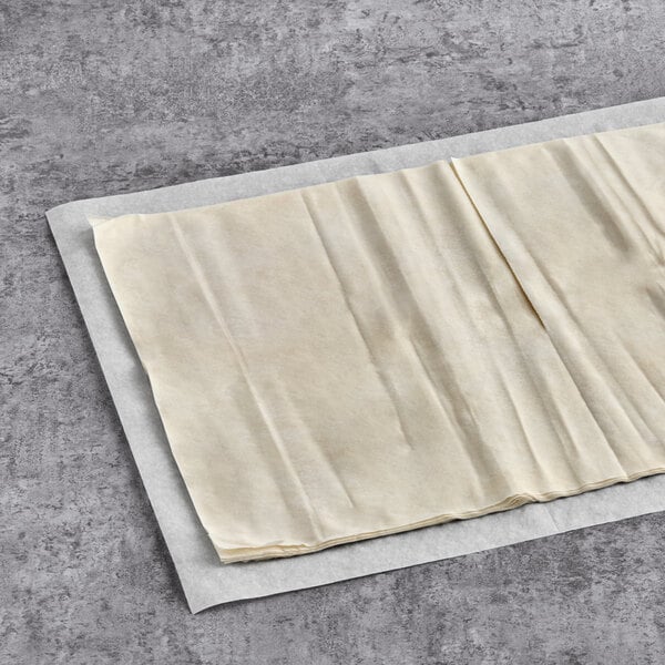 Kontos Fillo Dough sheets in folded white paper.