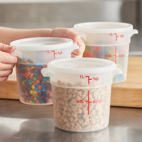 A set of translucent round polypropylene food storage containers with lids, each marked with measurement lines and filled with various food items.