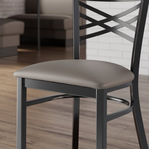 A dark gray vinyl padded seat for a metal chair.