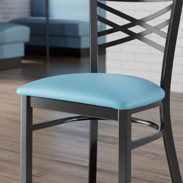 A Lancaster Table & Seating blue vinyl padded seat on a black metal chair.