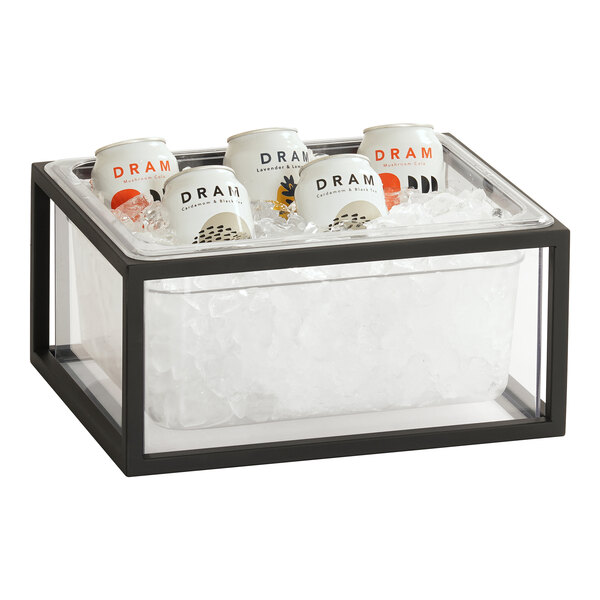 A black metal Cal-Mil ice housing container with a polycarbonate liner holding cans of beverages on a table.