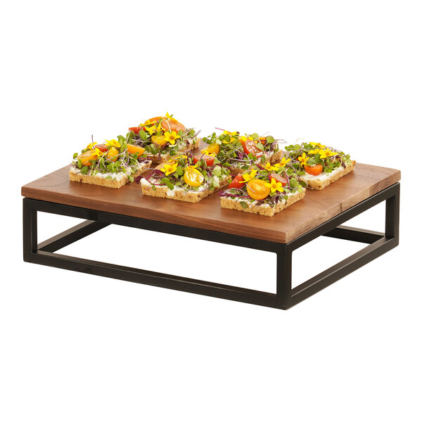 A black metal Cal-Mil rectangular display riser holding a variety of food on a table.