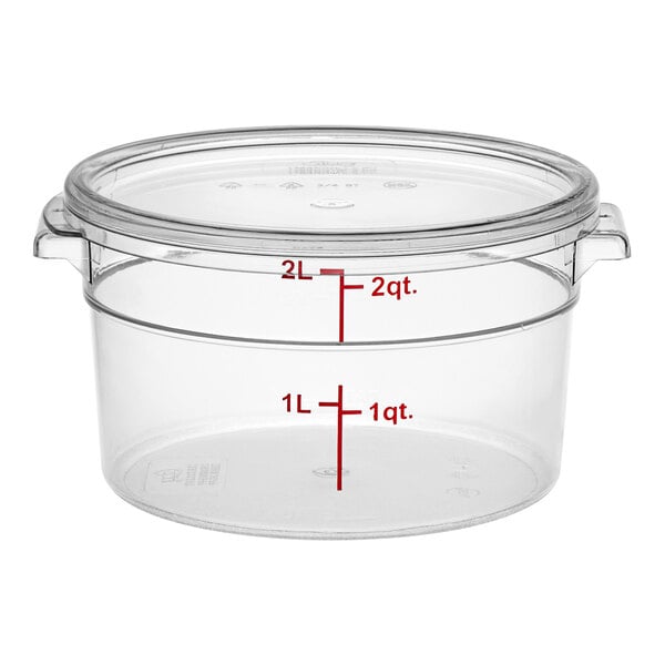 A clear round polycarbonate food storage container with a lid and measurement markings.