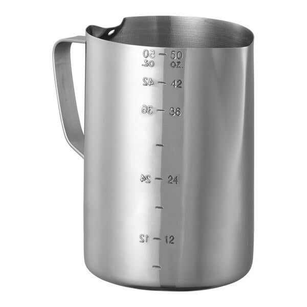 A stainless steel Service Ideas frothing pitcher with measuring lines on a white background.