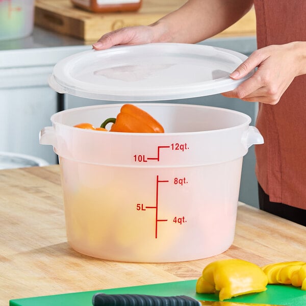 A translucent 12-quart round polypropylene food storage container with a lid and red measurement markings.