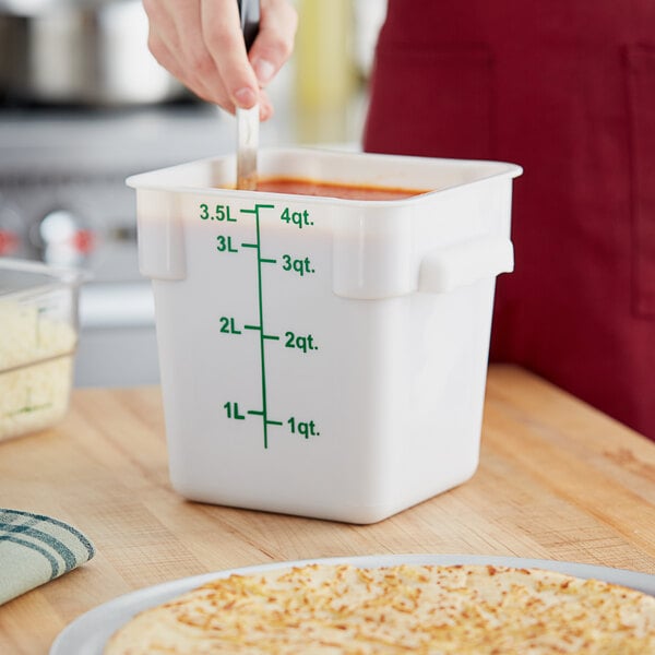 A white square polypropylene food storage container with green measurement markings and a green lid, holding up to 4 quarts or 3.5 liters.