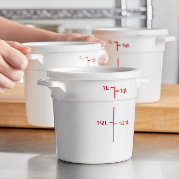 A white 1-quart round polypropylene food storage container with a lid and red measurement markings.