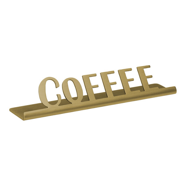 A vintage gold stainless steel "Coffee" tabletop sign on a counter.