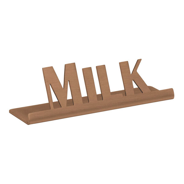 A rose gold stainless steel tabletop sign with the word "Milk" on it.