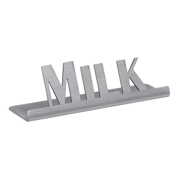 A brushed stainless steel metal tabletop sign that says "Milk"