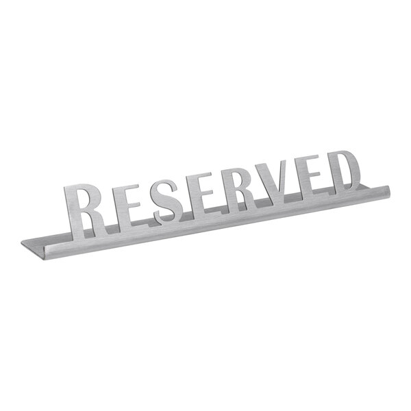 A brushed stainless steel tabletop "Reserved" sign with silver letters.