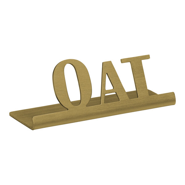 A vintage gold stainless steel "Oat" Tabletop Sign on a table.