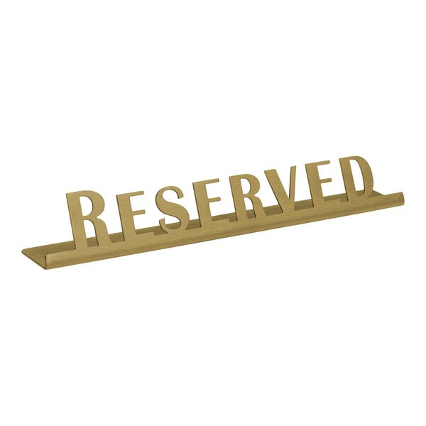 A vintage gold stainless steel "Reserved" tabletop sign.