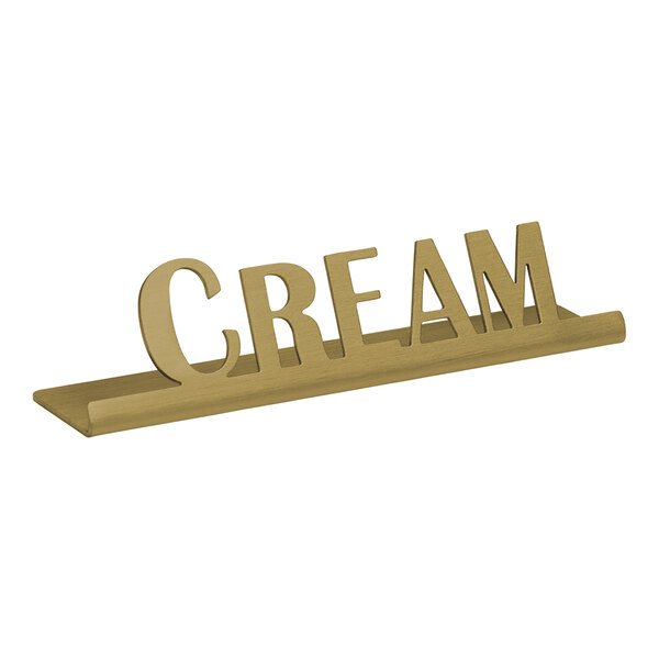 A vintage gold stainless steel "Cream" tabletop sign.