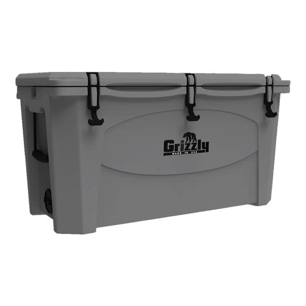 A grey Grizzly Cooler with black handles and wheels.