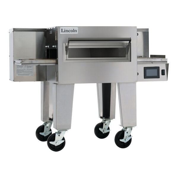 A commercial stainless steel electric conveyor oven with a wide belt and caster wheels.