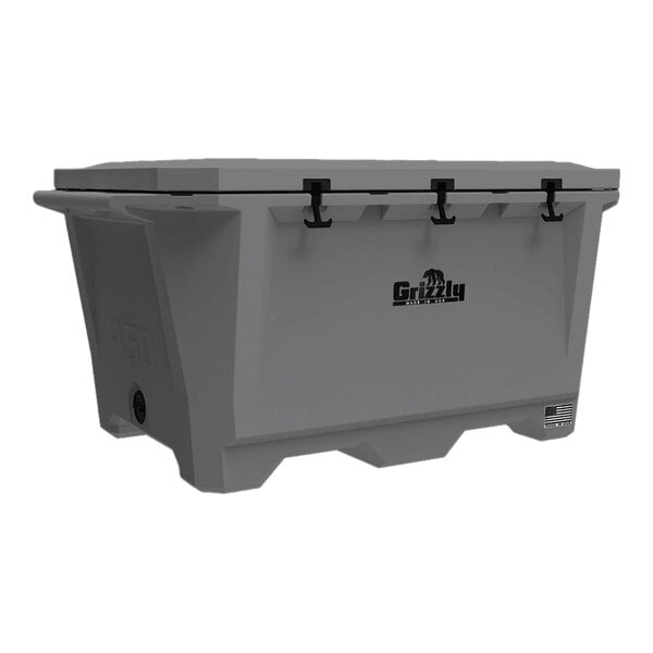 A grey Grizzly outdoor cooler with black handles.