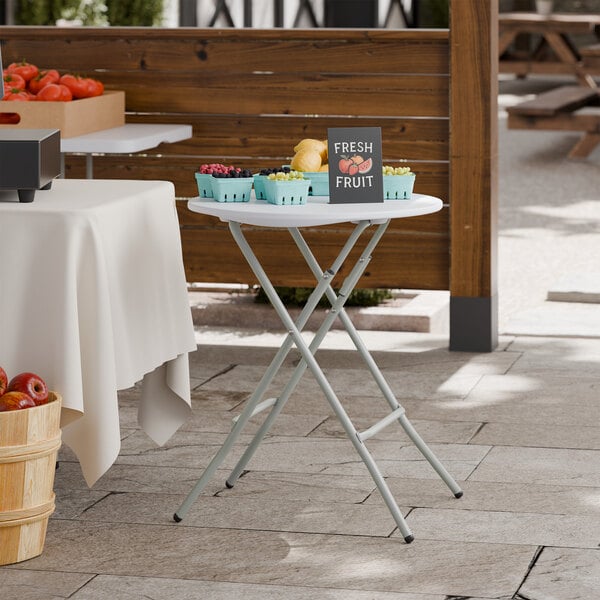A 24-inch round granite white plastic folding table with gray legs, designed for standard height and heavy-duty use.