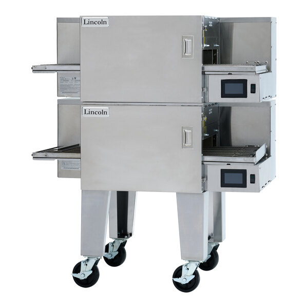 A double stacked stainless steel electric conveyor oven with two 16 3/4-inch wide belts and digital controls, mounted on wheels.