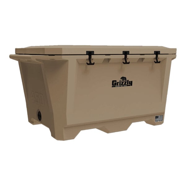 A large tan Grizzly Cooler with black handles.