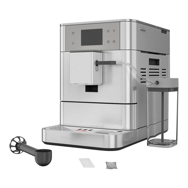 A silver Kitchen Aid espresso machine with a glass container on the side.