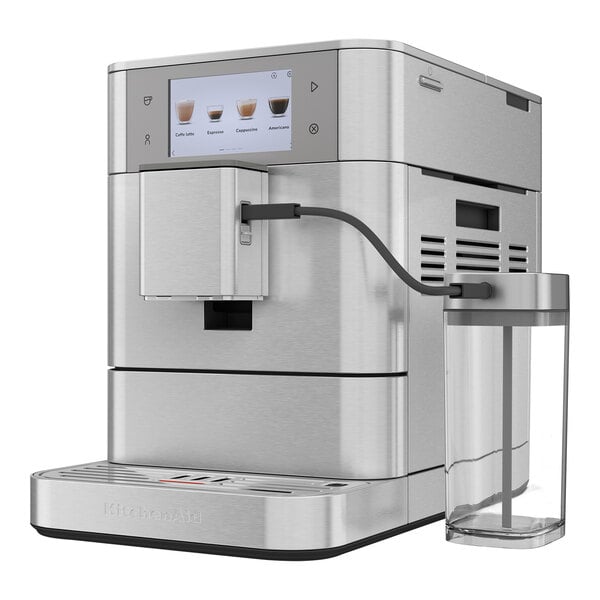 A silver Kitchen Aid espresso machine with a glass container on the side.