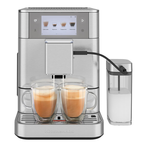 A Kitchen Aid stainless steel espresso machine with two cups of liquid.