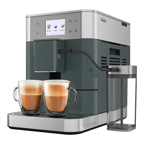 A Kitchen Aid espresso machine with two cups of brown liquid on the side.