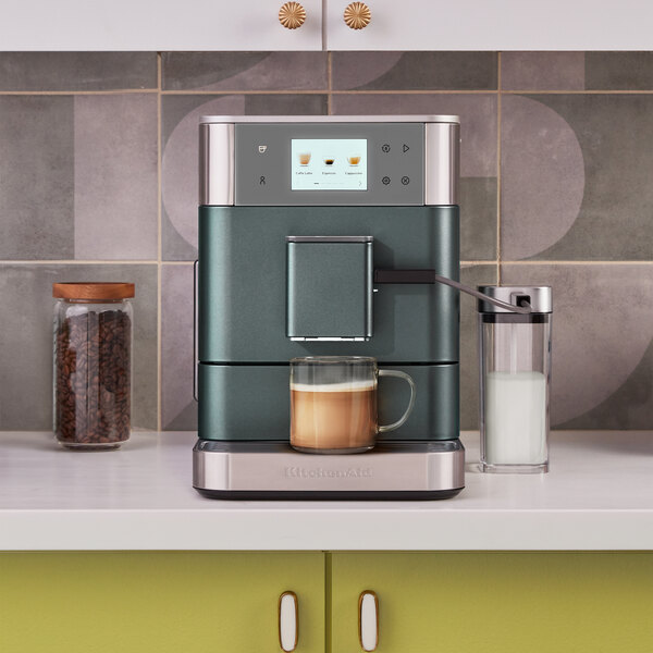 A KitchenAid juniper espresso machine on a counter.
