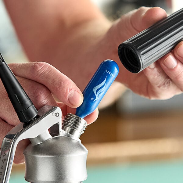 A person's hands using a blue and black Kayser N20 charger.