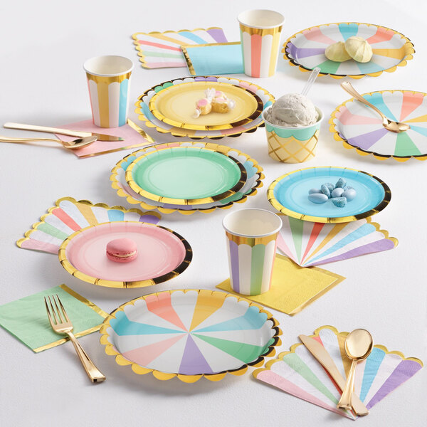 A table set with pastel napkins, plates, and cups.