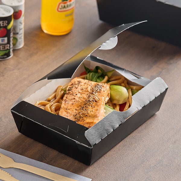 A Southern Champion folded paper take-out container with food inside.