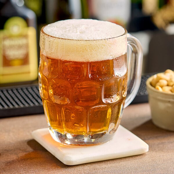 A glass of Citrone beer sitting on a bar coaster.
