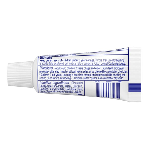 A close-up of a white Colgate toothpaste tube with blue text.