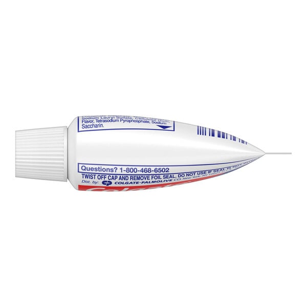 A close-up of a white Colgate toothpaste tube with blue and red text.