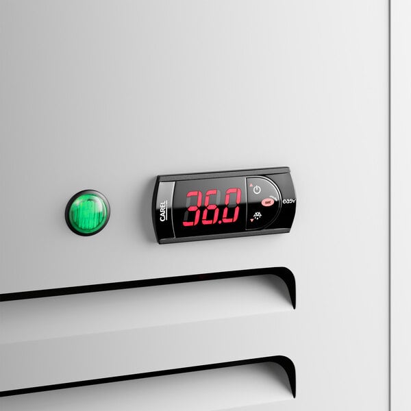 A white swing glass door merchandiser refrigerator with a digital temperature display and a green indicator light.