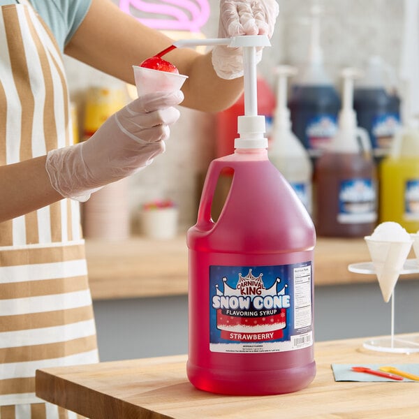 A gallon jug of Carnival King Strawberry Snow Cone Flavoring Syrup with a pump dispenser.
