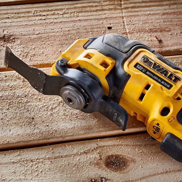 A yellow and black cordless DCS353B saw on a wood surface.