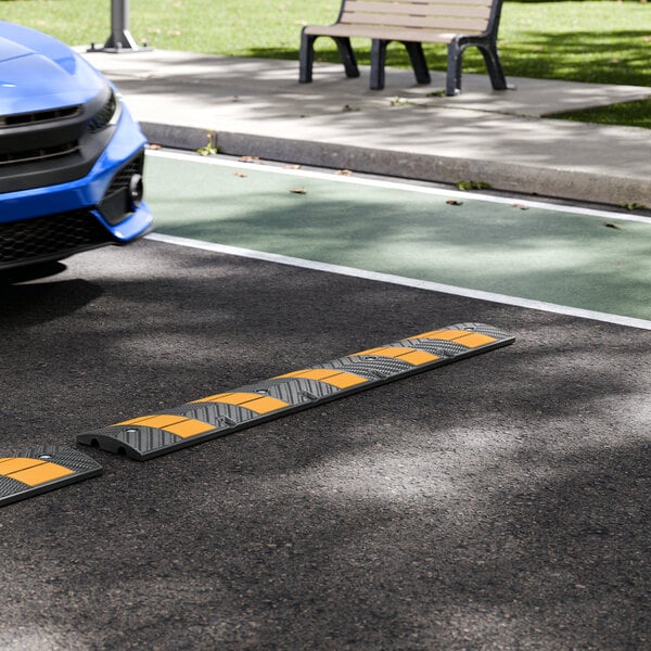 Lavex 6' Black and Yellow Heavy-Duty Rubber Speed Bump with 8 Cat Eye Reflectors and 5 Reflective Stripes