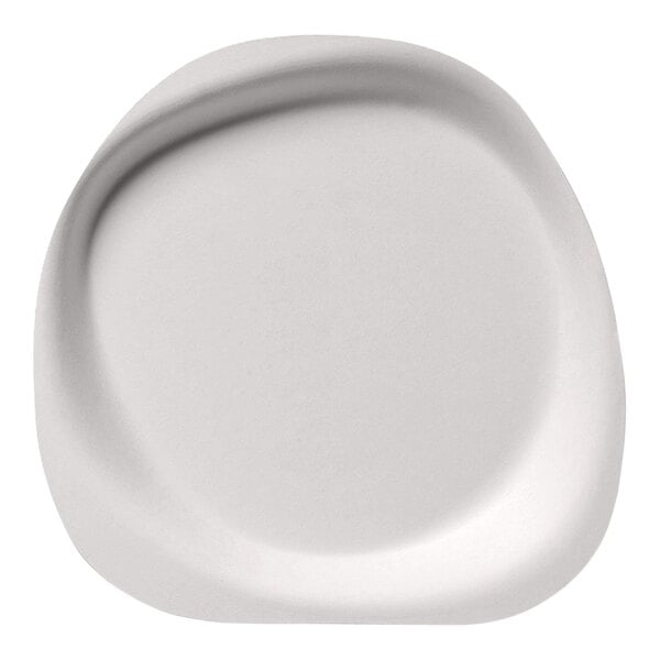 A close-up of a white Jungle Stone compostable sugarcane pulp plate with a curved edge.
