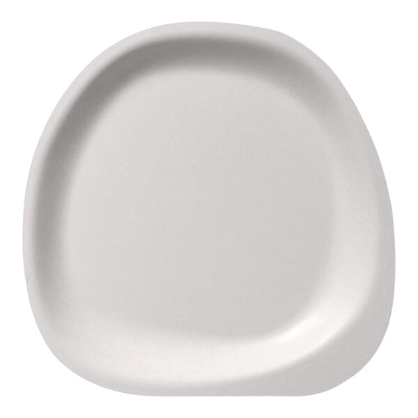 A close-up of a Jungle Stone compostable sugarcane pulp plate with a rounded edge.