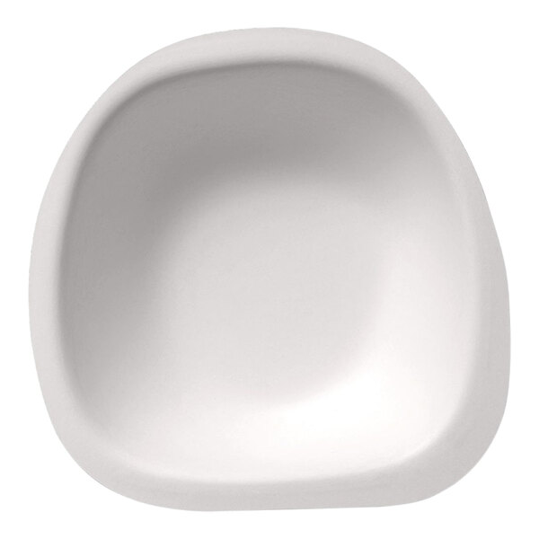 A white Jungle Stone compostable sugarcane pulp bowl with a rounded edge.