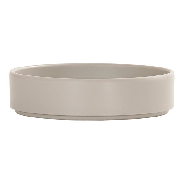 A round, light gray melamine plate with a raised rim.