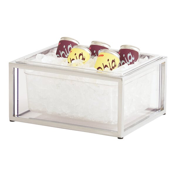 A clear Cal-Mil ice housing container with a polycarbonate liner holding cans on a counter.