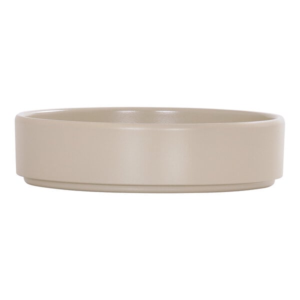 A taupe-colored melamine plate with a raised rim.